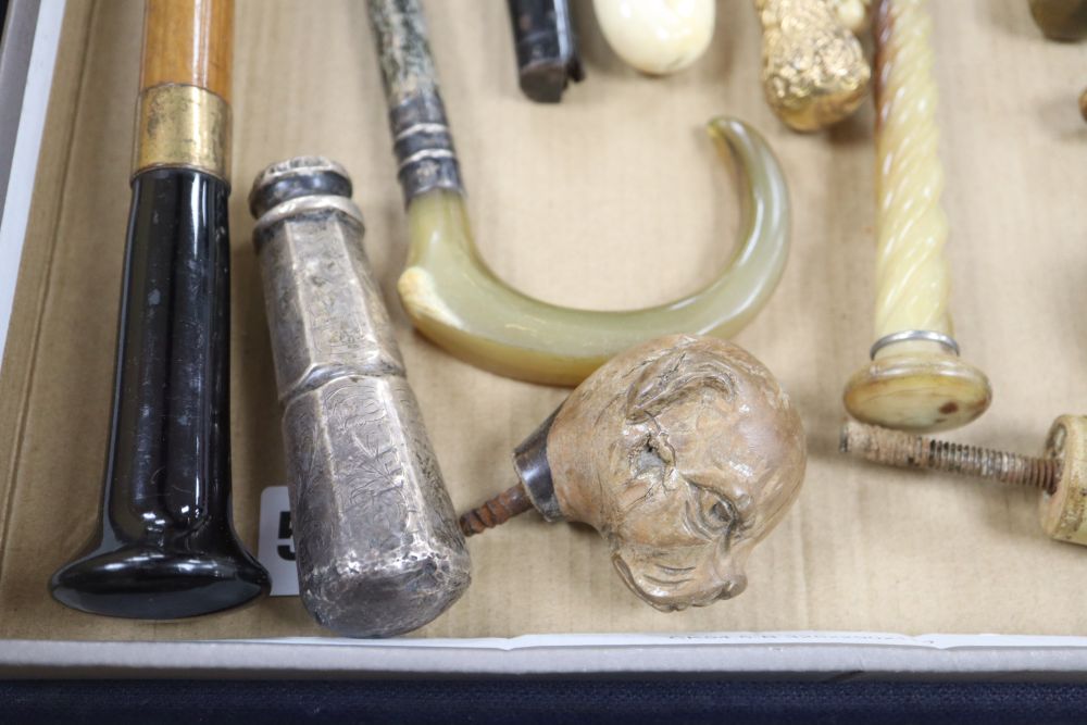 A group of silver, gilt metal and ivory walking cane and parasol handles.